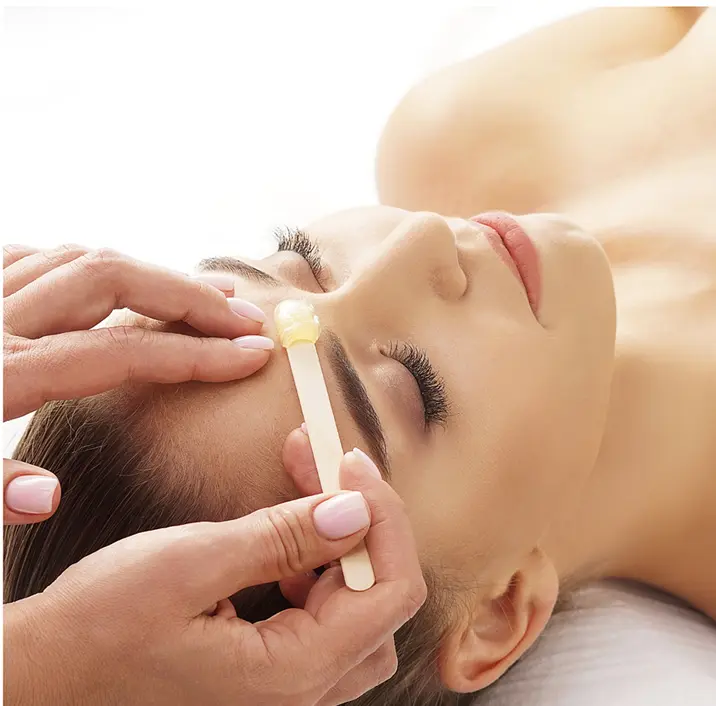 Woman getting eyebrows waxed